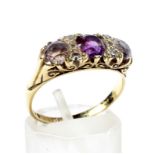 A vintage 18ct gold, amethyst and smoky-quartz three stone carved half-hoop ring