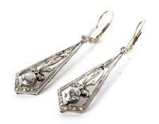A pair of early 20th century platinum and diamond pendent earrings.