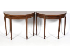 A pair of Georgian mahogany demi-lune side tables.