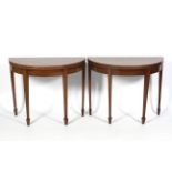 A pair of Georgian mahogany demi-lune side tables.