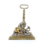 A late 19th/early 20th century weighted brass doorstop in the form of a lion attacking a serpent.