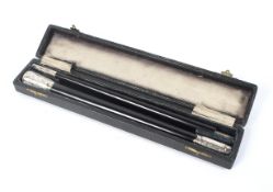 A cased silver mounted ebonised conductor's baton in two parts.