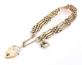 A vintage gold part-textured four-bar 'gate' bracelet on a padlock clasp.