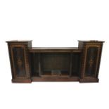 A Victorian walnut marquetry inlaid inverted break-front drop centre open bookcase.