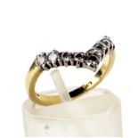 A modern 18ct gold and diamond nine stone wishbone ring.