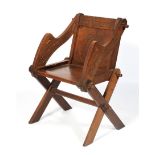 A 20th century carved oak Glastonbury elbow chair.