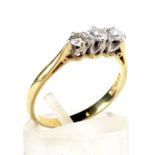 A vintage 18ct gold and diamond three stone ring. The graduated round brilliants approx. 0.