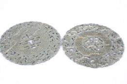 Two carved Chinese mottled green and white hardstone discs.