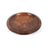 A treen burr walnut shallow circular bowl. With broad rim, incised JARRAH RS, 30.5cm diam.