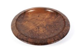 A treen burr walnut shallow circular bowl. With broad rim, incised JARRAH RS, 30.5cm diam.