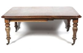 A Victorian mahogany windout dining table with extra leaf.