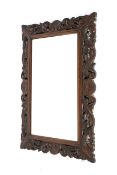 An early 20th century oak framed, bevel edged wall mirror. With pierced acanthus frame. 92cm x 65cm.