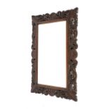 An early 20th century oak framed, bevel edged wall mirror. With pierced acanthus frame. 92cm x 65cm.