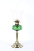 A Victorian brass oil lamp with etched shade.