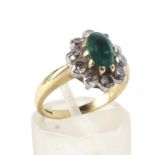 A modern 18ct gold, emerald and diamond oval cluster ring.
