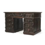 An early 20th century, Jacobian style oak twin pedestal desk. With allover carved decoration.