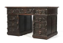 An early 20th century, Jacobian style oak twin pedestal desk. With allover carved decoration.