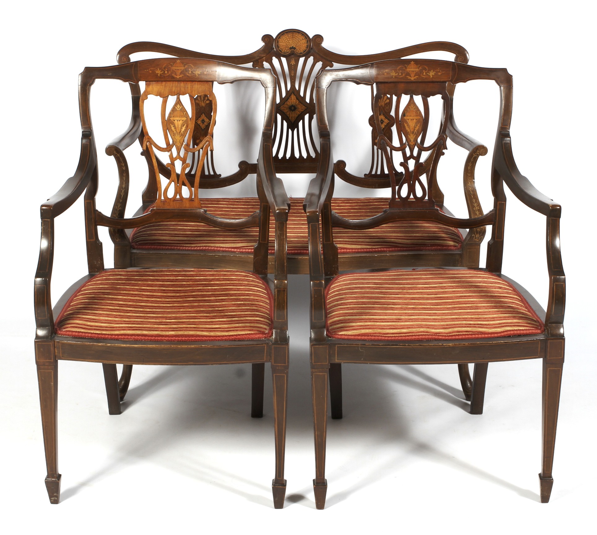 An Edwardian mahogany and marquetry salon suite with a two-seater sofa and two armchairs.