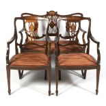An Edwardian mahogany and marquetry salon suite with a two-seater sofa and two armchairs.