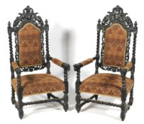 A pair of large early 20th century stained oak throne armchairs.