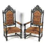 A pair of large early 20th century stained oak throne armchairs.