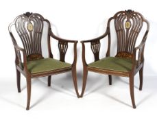 A fine pair of Edwardian inlaid Sheriton Revival elbow chairs.