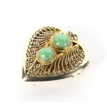 A Far Eastern yellow metal and jadeite two stone heart-shaped locket.