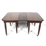 A Regency mahogany pull out extending dining table with two extra leaves.