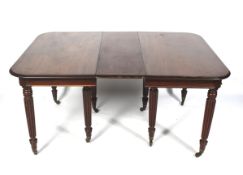 A Regency mahogany pull out extending dining table with two extra leaves.