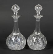 A pair of Victorian cut-glass shaft and globe decanters and stoppers.