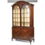 A Queen Anne style mahogany glazed cabinet on cupboard base.