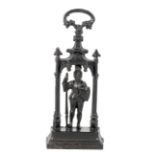 A late 19th century cast iron door stop in the form of a knight within a Gothic arch.