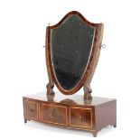 A Regency mahogany shield-shaped dressing table mirror.