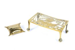 A 19th century pierced brass trivet and a pierced cushion-shaped potpourri.