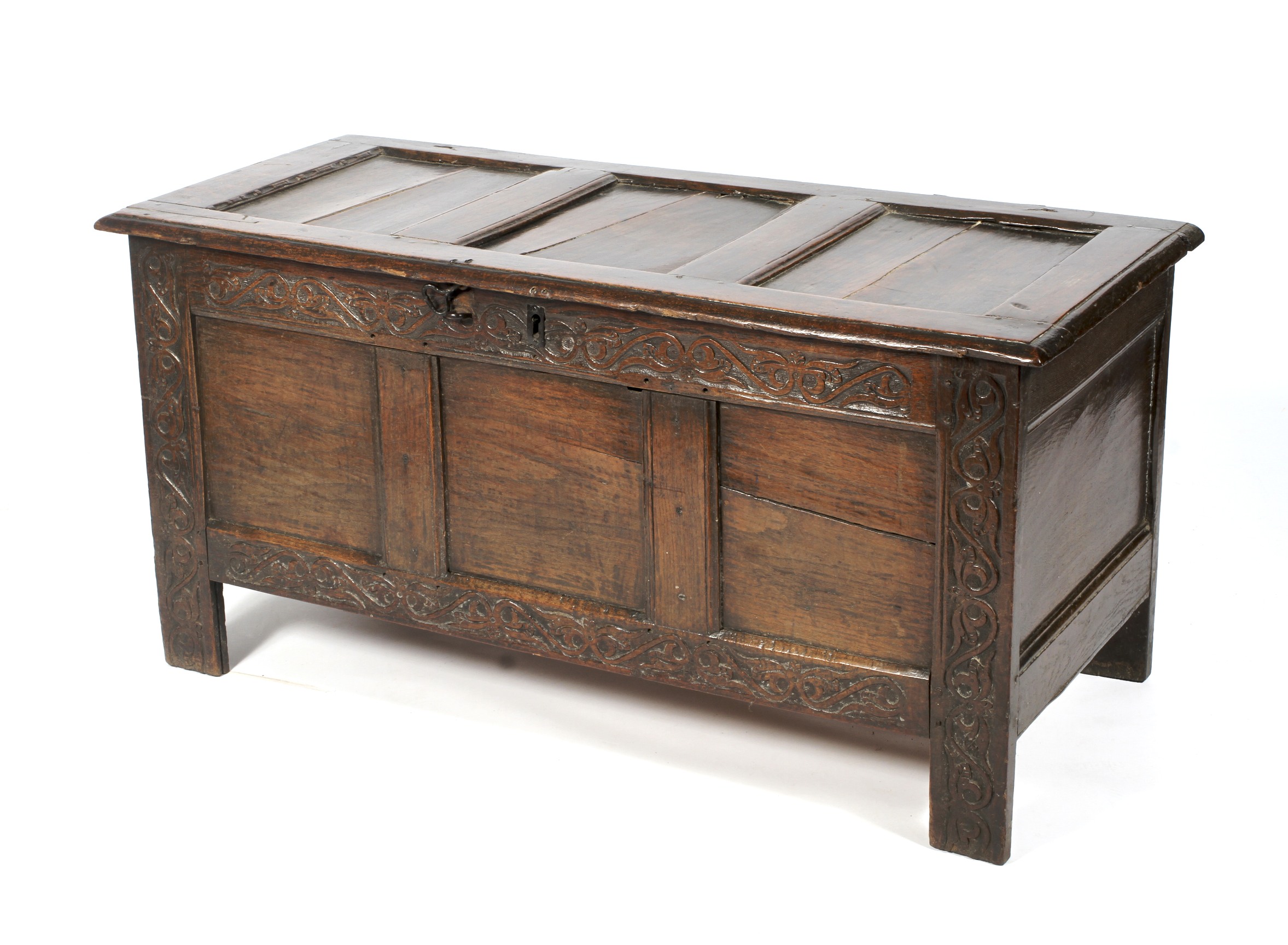 A panelled and carved oak coffer, late 17th century.