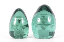 Two Victorian green tinted glass dump weights in sizes.