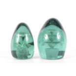 Two Victorian green tinted glass dump weights in sizes.