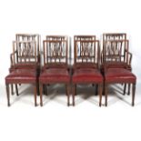 A set of eight Edwardian inlaid mahogany dining chairs with pierced splats.