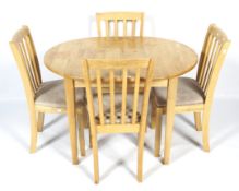 A beech extendable kitchen table and four chairs.