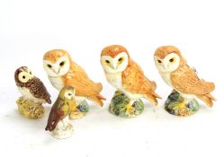 A parliament of five owls. Comprising four Beswick owls (the largest three each 11.