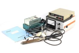 Three vintage items of electrical testing equipment and a soldering iron.