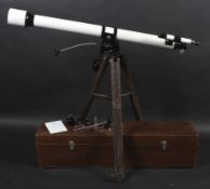 An unbranded astronomical telescope on a wooden tripod stand and accessories.