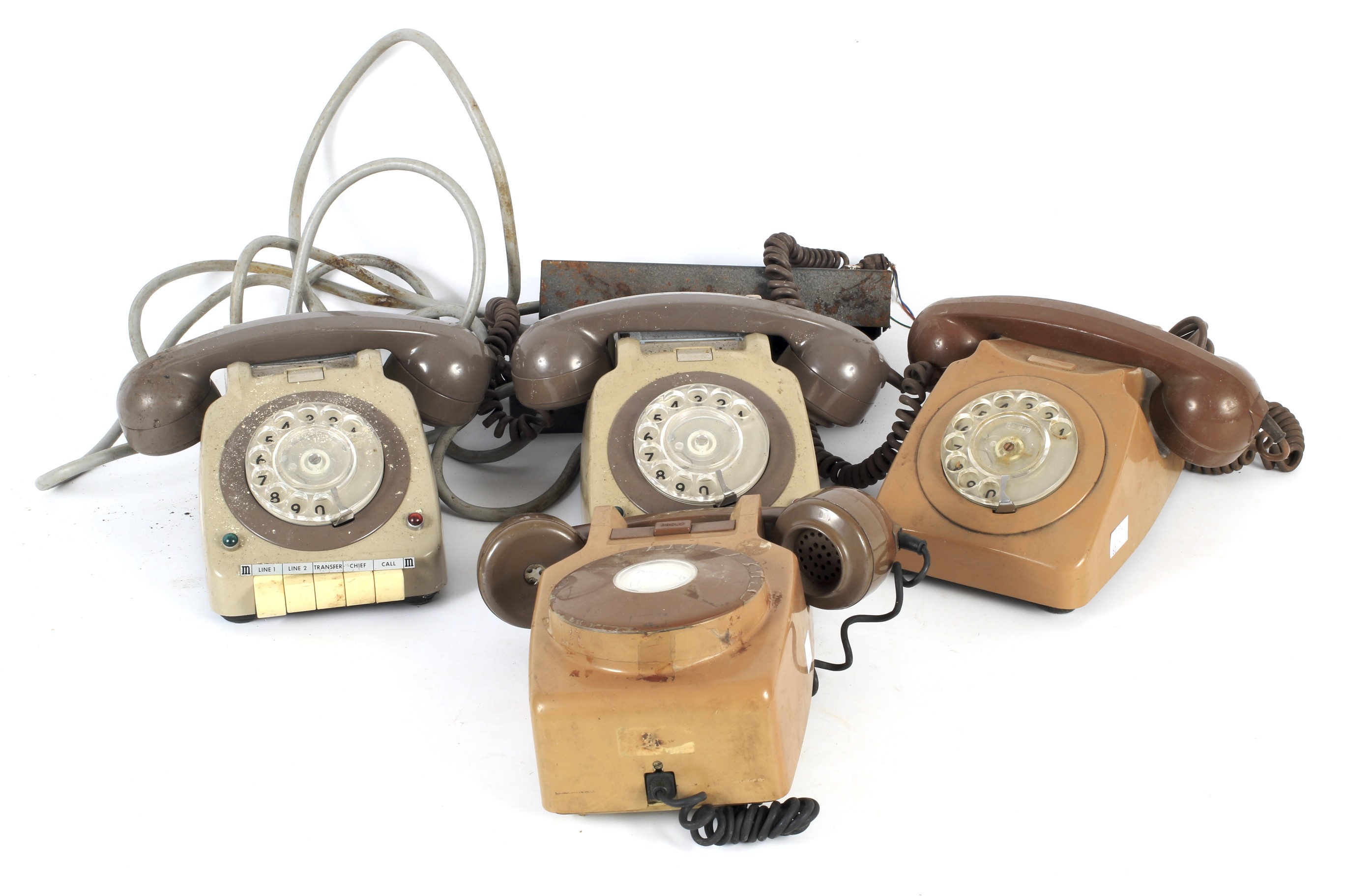 Three vintage mechanical rotary dial telephones.