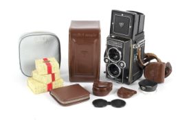 A Rollei Magic medium format TLR camera and various accessories.
