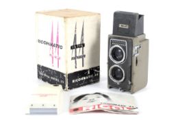 A Ricoh Ricohmatic 4x4 TLR camera. With a 60mm 1:3.5 lens.