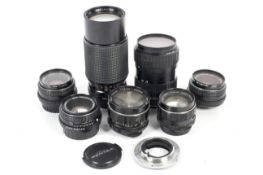 Seven Asahi Pentax and Asahi Pentax fit lenses and a Canon to Pentax KM lens adaptor.