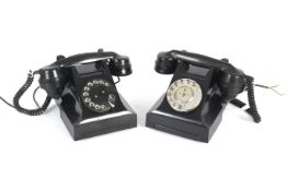 Two rotary black Bakelite telephones.