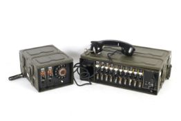 A FSP-Vermittlung military field telephone switchboard and a metal cased rotary dial.
