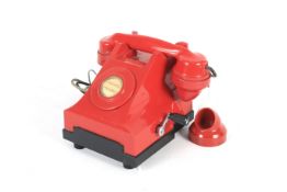 A vintage red party line telephone.