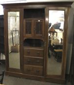 An Art Nouveau mahogany triple wardrobe.